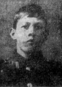 Newspaper photo of a soldier in uniform, head and shoulders only.